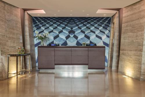 a lobby with a reception desk in a building at Meliá Genova in Genova