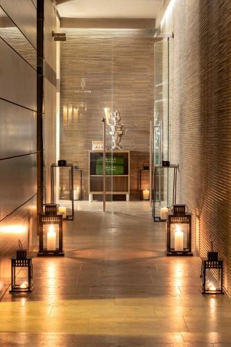 a lobby with lights and a brick wall at Meliá Genova in Genova