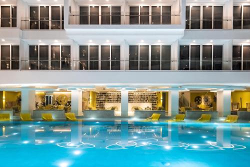 a hotel lobby with a large swimming pool at Astoria Current in Boracay