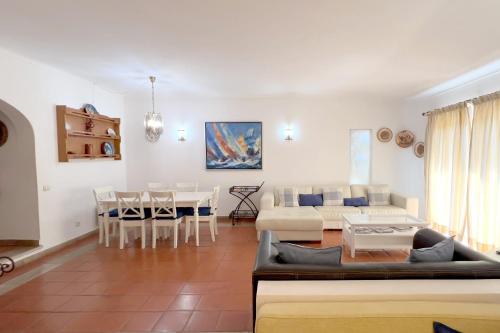 a living room with a couch and a table at Villa Dantas by amcf in Vilamoura