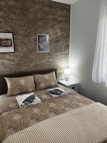 a bedroom with a bed with two pillows on it at Sunflower Apartmani in Soko Banja