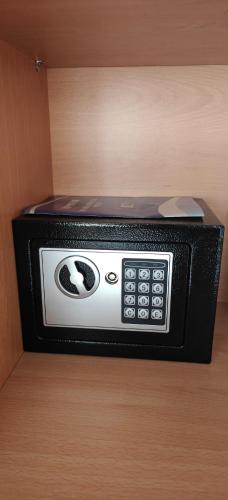 a black and white microwave sitting on a shelf at Lipsi Sands in Lipsoi