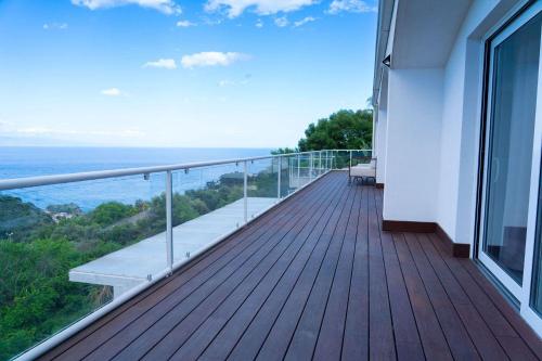 a balcony of a house with a view of the ocean at Villa Zagara Garden Spectacular Sea View in Taormina in Taormina