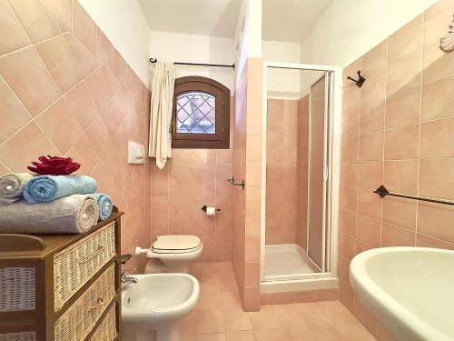 a bathroom with a toilet and a sink and a shower at Mono 4 pax - Terrazza - Piscina & Parcheggio in Baja Sardinia