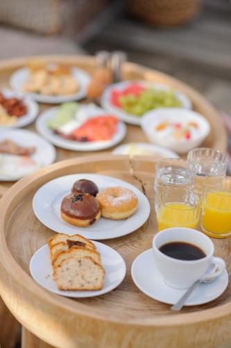 a table with plates of breakfast foods and a cup of coffee at Selini Ηotel in Kamari