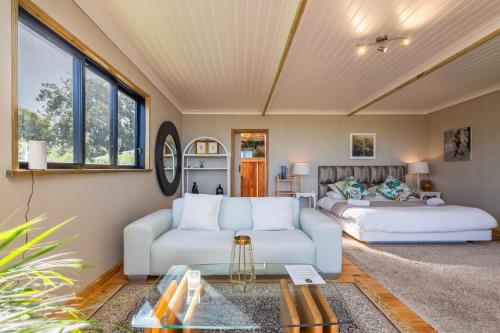 a living room with a couch and a bed at Kyles Forest Cabin in Kafferkop