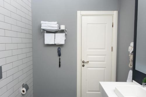 a bathroom with a white door and white towels at Vita Suites Karaköy in Istanbul
