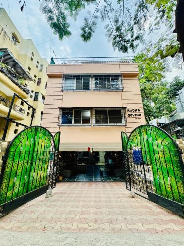 a building with two gates in front of it at Hotel Elite Stay - Nilanjali Society, Kalyani Nagar, Pune in Pune