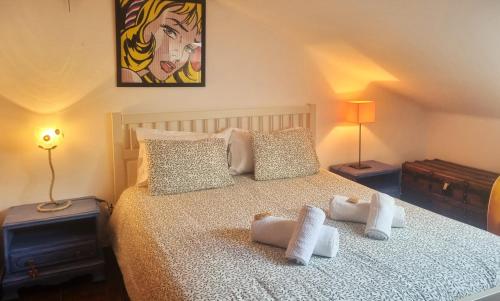 a bedroom with a bed with towels on it at CASA MILFONTES by Stay in Alentejo in Vila Nova de Milfontes