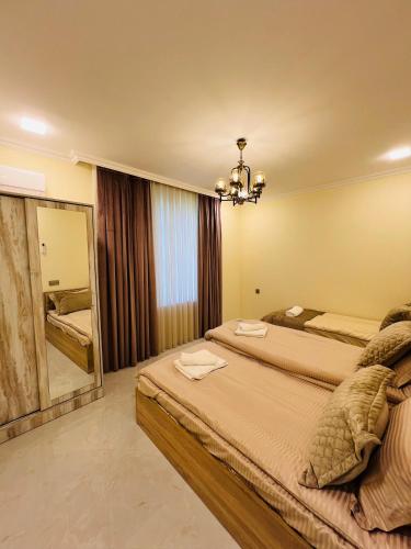 a bedroom with two beds and a large mirror at Gabala Breeze Villa in Gabala