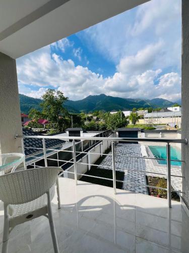 a balcony with a view of a pool and mountains at Gabala Breeze Villa in Gabala