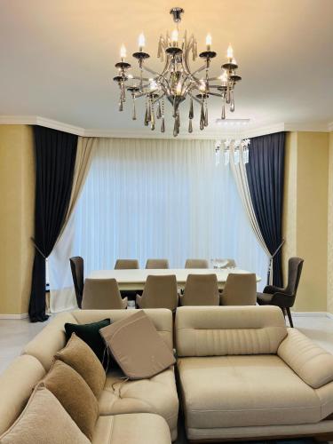 a living room with a large couch and a table at Gabala Breeze Villa in Gabala