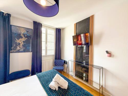 une chambre avec un lit et un canapé bleu dans l'établissement Urban Flat 176 - Charming 3 Bedroom in Montorgueil, à Paris