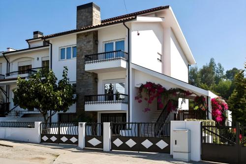 a white house with flowers on the balconies at Spacious Villa in Vila Nova de Gaia in Vila Nova de Gaia