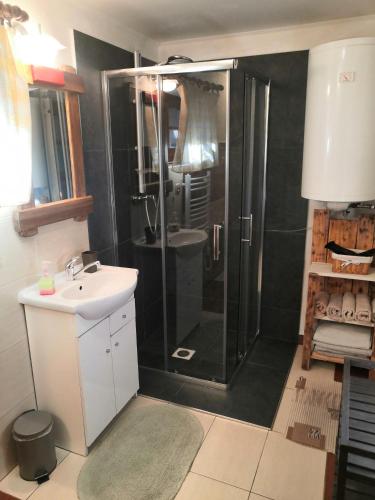 a bathroom with a shower and a sink at Drevenica pod Tlstou in Blatnica