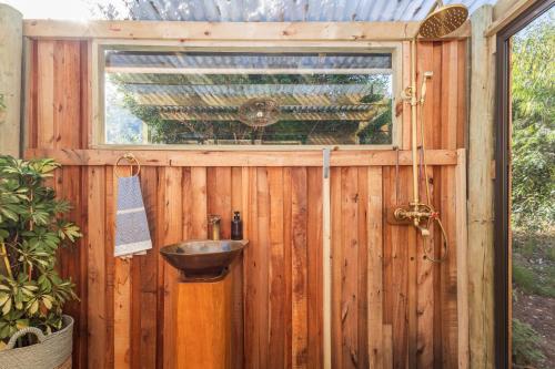 a wooden shed with a sink and a window at Kyles Forest Cabin in Kafferkop