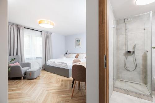a bedroom with a bed and a walk in shower at Nowy Hotel Monika - by Upstairs in Kraków