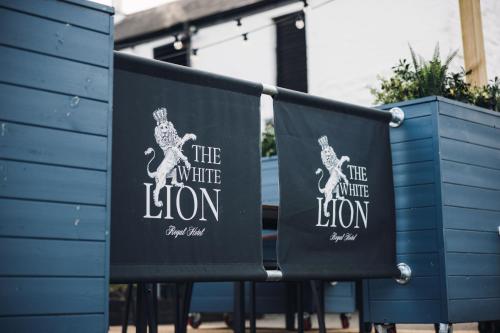 two black chairs with the white lion on them at White Lion Royal Hotel in Bala