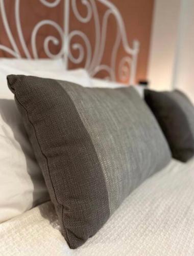 a bed with two pillows on top of it at Athenian Coastal Urban Living in Athens