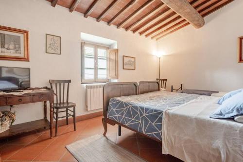 a bedroom with a bed and a table and a desk at Ala di Maniero in Agriturismo Valdrago in Toscana, nel Verde Mugello sulle Colline di Firenze Autodromo Mugello Circuit in Borgo San Lorenzo