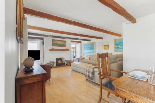 a living room with a couch and a table at Budle Newton - North East Escapes in Bamburgh