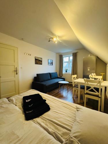 a bedroom with a bed and a couch and a table at Casa de Rainer Copenhagen Room 3 in Copenhagen