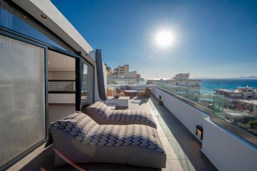 a balcony with two beds and a view of the ocean at The Gem Loft City Apartment in Rhodes Town