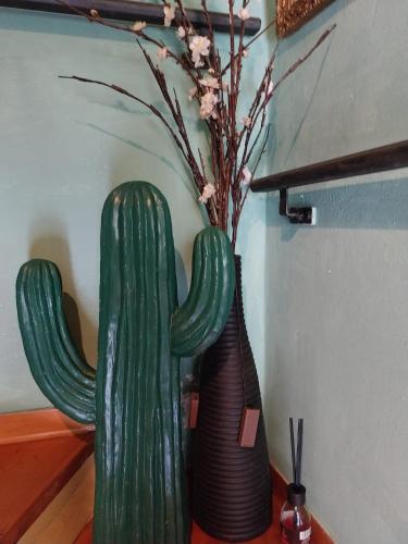 two vases sitting on a table next to a cactus at Casita Esperanza in Copparo