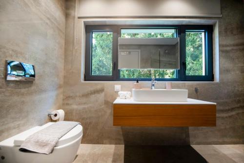 a bathroom with a sink and a window at The Gem Loft City Apartment in Rhodes Town
