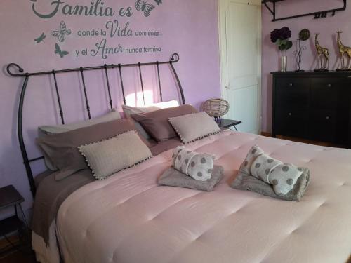 a large white bed with two pillows on it at Casita Esperanza in Copparo