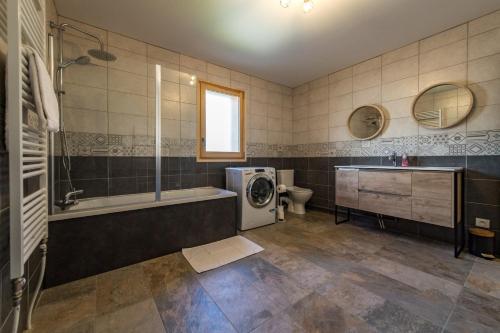 a bathroom with a washing machine and a sink at Renovated apartment with terrace for 14 people in Saint-Jean-de-Maurienne
