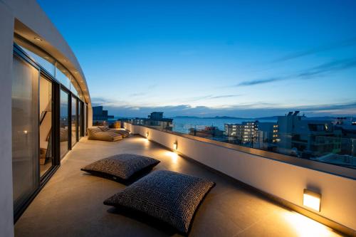 a balcony with pillows and a view of a city at The Gem Loft City Apartment in Rhodes Town