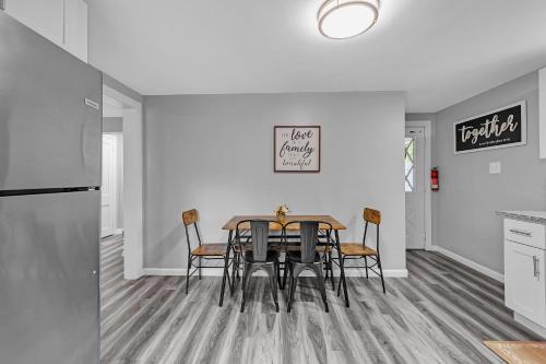 a kitchen and dining room with a table and chairs at Pet-Friendly 4BR Near Kennywood & Pittsburgh home in West Mifflin