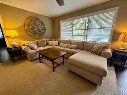 a living room with a couch and a table at Old town Bluffton Charm, BEST LOCATION Calhoun St. in Bluffton