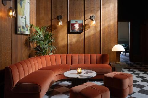 a living room with a couch and a table at JA Mar Hall Scotland in Bishopton