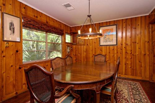 a dining room with a wooden table and chairs at Old town Bluffton Charm, BEST LOCATION Calhoun St. in Bluffton