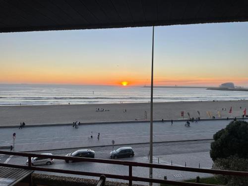 a view of the beach at sunset from a balcony at Porto - Sunset flat at the beach - Free parking in Matosinhos