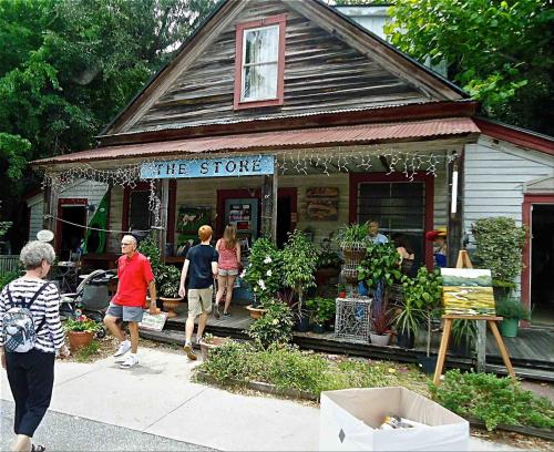 a group of people walking in front of a store at Old town Bluffton Charm, BEST LOCATION Calhoun St. in Bluffton