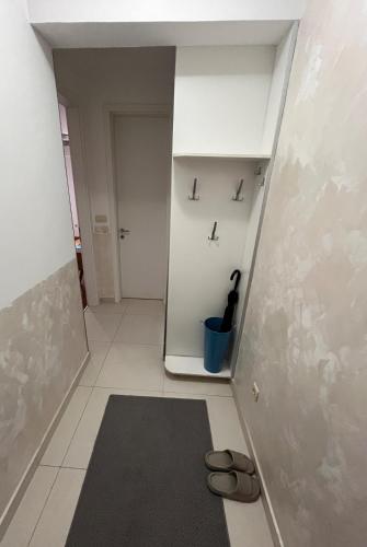 a hallway with a pair of shoes on the floor at DOWNTOWN apartment Old Town in Podgorica