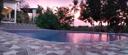 a swimming pool in the backyard of a house at Matteo's hus VILLA RENTAL in Zamboanguita