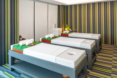 two beds in a room with striped walls at Astoria Current in Boracay
