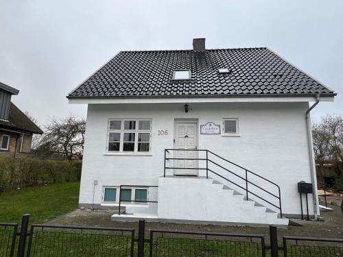 a white house with a staircase in front of it at Casa de Rainer Copenhagen Room 3 in Copenhagen