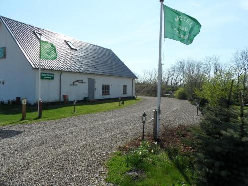 a flag on a pole in front of a building at Motel Herning in Kibæk