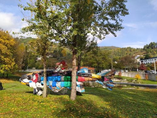 a park with a tree with a painting on it at Dona Irene AL in Manteigas