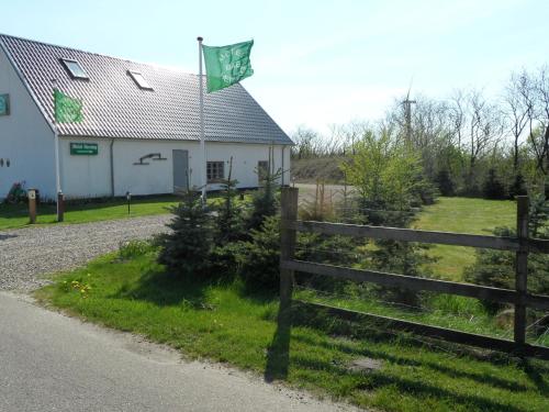 a flag on a fence next to a house at Motel Herning in Kibæk