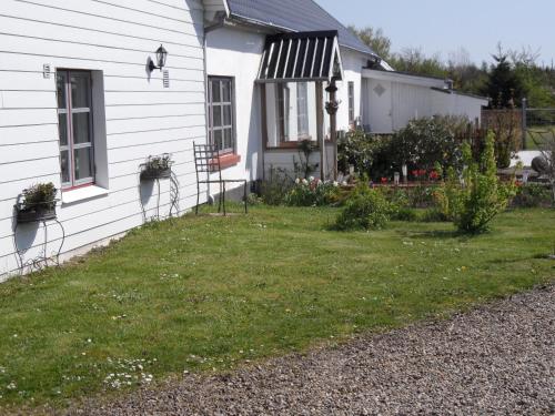 a house with a yard next to a building at Motel Herning in Kibæk