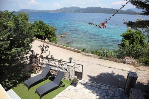 a couple of chairs sitting next to a body of water at Salt and Sun in Nikiana