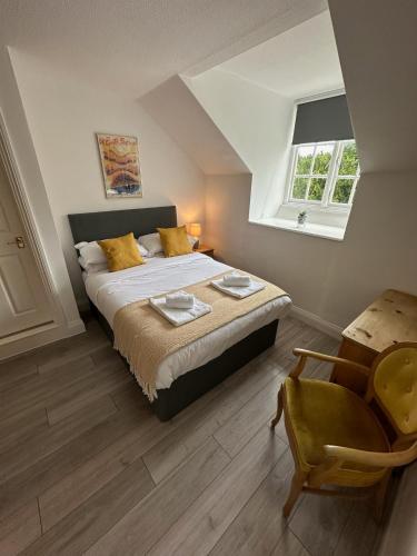 a bedroom with a bed and a chair and a window at The Beeches - Entire Mansion in Bristol
