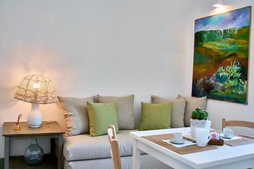 a living room with a couch and a table at Casa Zizzi - appartamento romantico per 2 in Puglia in Montalbano