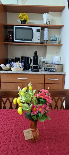 a vase filled with flowers sitting on a table at Manuel's House - Torre Maura in Rome